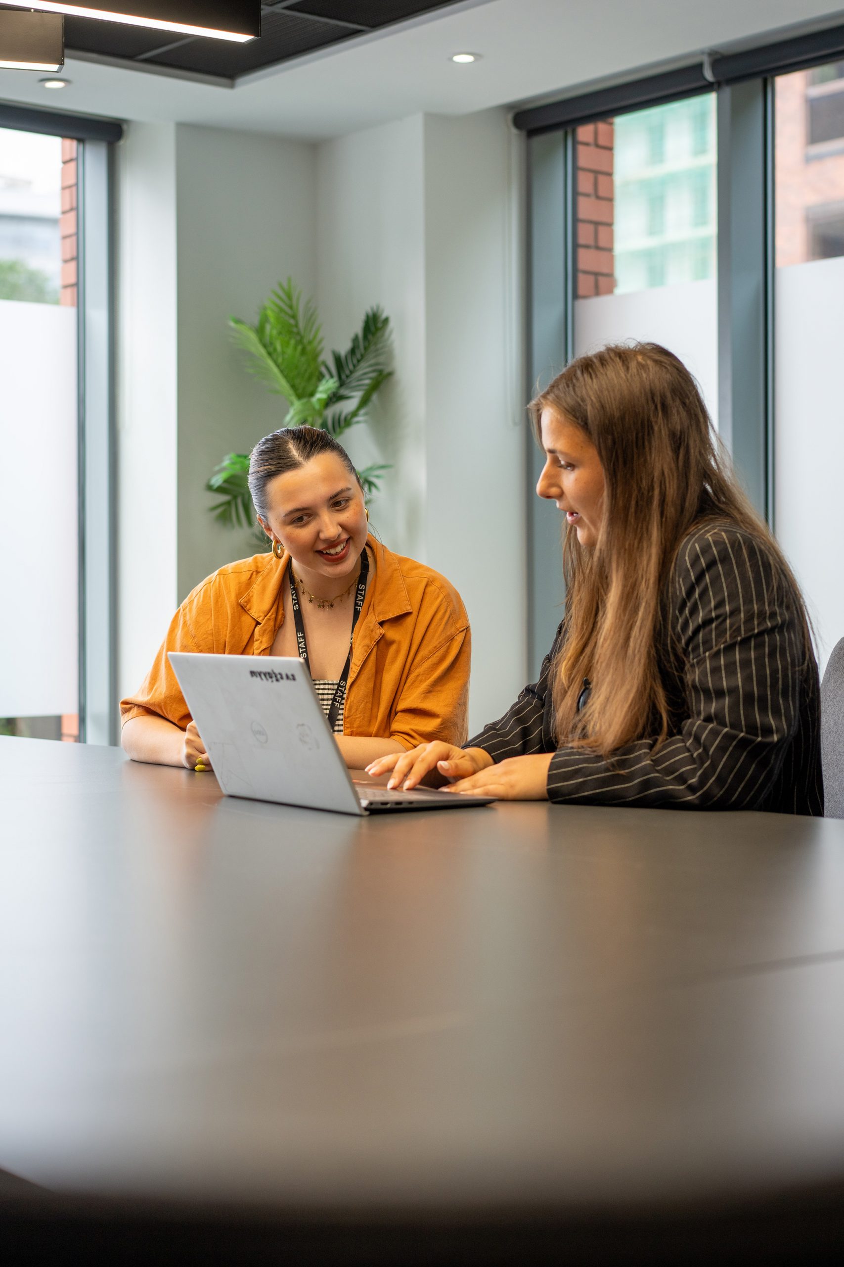 Two women working on a laptop